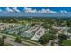 Aerial view of the Countryside community featuring tennis courts, golf course, and clubhouse at 3021 Countryside Blvd # 26A, Clearwater, FL 33761