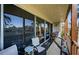Inviting balcony with comfortable seating and a picturesque view of the surrounding landscape and tennis courts at 3021 Countryside Blvd # 26A, Clearwater, FL 33761