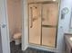 Cozy bathroom featuring a shower with glass door and commode at 3021 Countryside Blvd # 26A, Clearwater, FL 33761