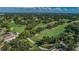 Scenic aerial shot of a well-maintained golf course featuring green fairways, mature trees, and tranquil ponds at 3021 Countryside Blvd # 26A, Clearwater, FL 33761