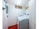 Laundry room featuring a modern washer and dryer with extra cabinet space at 3021 Countryside Blvd # 26A, Clearwater, FL 33761