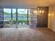 Bright living room with sliding glass doors opening to a patio and tennis court views at 3021 Countryside Blvd # 26A, Clearwater, FL 33761