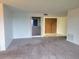 Neutral living room showcases neutral carpet and direct view of front door at 3021 Countryside Blvd # 26A, Clearwater, FL 33761