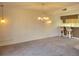 Spacious living room features carpet and is adjacent to kitchen bar seating at 3021 Countryside Blvd # 26A, Clearwater, FL 33761