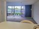 Living room with sliding glass doors leading to a patio overlooking a tennis court at 3021 Countryside Blvd # 26A, Clearwater, FL 33761
