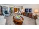 Open living room featuring a large tv, plush seating, and stylish decor at 3021 Countryside Blvd # 26A, Clearwater, FL 33761