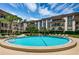 Inviting community pool surrounded by lush landscaping and comfortable lounge chairs perfect for relaxation at 3021 Countryside Blvd # 26A, Clearwater, FL 33761