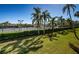 Well-maintained tennis courts surrounded by lush greenery and palm trees on a clear day at 3021 Countryside Blvd # 26A, Clearwater, FL 33761
