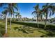 Beautiful community tennis courts with palm trees, blue skies, and a lush green lawn at 3021 Countryside Blvd # 26A, Clearwater, FL 33761