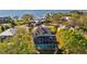 Beautiful home with an outdoor pool and screened-in patio, surrounded by lush landscaping and water views at 3114 Bluff Blvd, Holiday, FL 34691