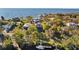 Expansive waterfront property aerial view, including a private dock and pool, surrounded by lush trees at 3114 Bluff Blvd, Holiday, FL 34691