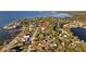 Aerial view of homes near the water with docks, surrounded by lush greenery and serene waters at 3114 Bluff Blvd, Holiday, FL 34691