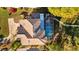 Stunning aerial view showcasing a private pool and a beautifully landscaped backyard in a serene setting at 3114 Bluff Blvd, Holiday, FL 34691