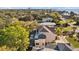 Large home with a screened-in pool and patio, nestled among mature trees with a serene residential view at 3114 Bluff Blvd, Holiday, FL 34691
