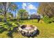 The backyard features a stone fire pit, perfect for gathering around with friends and Gathering at 3114 Bluff Blvd, Holiday, FL 34691