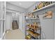 Basement space with bar cart, shelves stocked with liquor, and access to the stairs at 3114 Bluff Blvd, Holiday, FL 34691