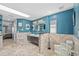 Spacious bathroom with double vanity, glass-block accents, and access to the Primary bedroom at 3114 Bluff Blvd, Holiday, FL 34691