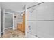 Bathroom with a glass enclosed tub and shower, vanity, and aquatic themed wall decor at 3114 Bluff Blvd, Holiday, FL 34691
