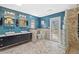 Bright bathroom boasts a double vanity, glass block shower, and access to a balcony at 3114 Bluff Blvd, Holiday, FL 34691