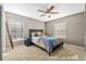 Cozy bedroom with a ceiling fan, and a comfortable bed with decorative pillows at 3114 Bluff Blvd, Holiday, FL 34691