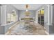Bright dining room featuring tile floors, natural light, and a modern chandelier at 3114 Bluff Blvd, Holiday, FL 34691