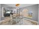 Open dining area featuring a modern table set and view into an adjacent living room at 3114 Bluff Blvd, Holiday, FL 34691