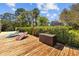 Inviting waterfront retreat with lounge chairs on a private wooden dock surrounded by lush landscaping at 3114 Bluff Blvd, Holiday, FL 34691