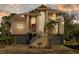 Inviting two-story home with a front-facing two-car garage, landscaped yard, and charming balcony at sunset at 3114 Bluff Blvd, Holiday, FL 34691