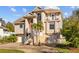 Inviting two-story home with a front-facing two-car garage, landscaped yard, and charming balcony at 3114 Bluff Blvd, Holiday, FL 34691