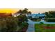 Beautiful home with lush landscaping and a sunset backdrop at 3114 Bluff Blvd, Holiday, FL 34691