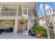 Exterior view of this home's outdoor living space, featuring a spiral staircase and a covered porch at 3114 Bluff Blvd, Holiday, FL 34691