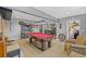 Open game room featuring a red pool table and offering plenty of room for seating at 3114 Bluff Blvd, Holiday, FL 34691
