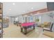 Spacious game room featuring a red pool table, recessed lighting, and comfortable seating at 3114 Bluff Blvd, Holiday, FL 34691