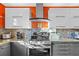 Kitchen featuring stainless steel appliances, modern white cabinetry, and stone tile backsplash at 3114 Bluff Blvd, Holiday, FL 34691