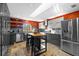 Modern kitchen featuring stainless steel appliances, gray cabinetry, and a center island at 3114 Bluff Blvd, Holiday, FL 34691