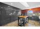 Modern kitchen featuring stainless steel appliances, dark gray cabinetry, and a center island with seating at 3114 Bluff Blvd, Holiday, FL 34691