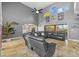 Spacious living room with tile floors, high ceilings, and a dark leather sofa at 3114 Bluff Blvd, Holiday, FL 34691