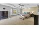 Spacious main bedroom with a ceiling fan, tray ceiling, and a decorative accent wall at 3114 Bluff Blvd, Holiday, FL 34691