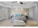 Large main bedroom features modern tray ceilings, neutral colors, and custom accent wall at 3114 Bluff Blvd, Holiday, FL 34691
