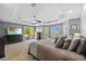 Well-appointed main bedroom with access to a private deck, ceiling fan, and neutral colors at 3114 Bluff Blvd, Holiday, FL 34691