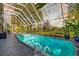 Outdoor screened pool area with mature landscaping and an inviting outdoor swimming pool at dusk at 3114 Bluff Blvd, Holiday, FL 34691