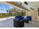 Spacious screened outdoor pool area with comfortable seating, ceiling fans, and a serene backyard view at 3114 Bluff Blvd, Holiday, FL 34691