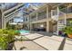 Enclosed outdoor pool area with a spiral staircase and comfortable seating, perfect for entertaining at 3114 Bluff Blvd, Holiday, FL 34691