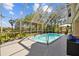 Enclosed pool area featuring a clear blue swimming pool and landscaped surroundings at 3114 Bluff Blvd, Holiday, FL 34691