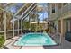 Enclosed outdoor pool with clear blue water, providing a perfect spot for relaxation at 3114 Bluff Blvd, Holiday, FL 34691
