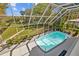 View of the pool and lush grounds from the screened in lanai at 3114 Bluff Blvd, Holiday, FL 34691