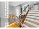 Modern staircase with wood treads, cable railings, and natural light at 3114 Bluff Blvd, Holiday, FL 34691