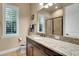 Bathroom featuring a granite vanity top, glass shower and large window at 3198 Thatcher Ln, Tarpon Springs, FL 34688