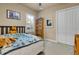 Bedroom showcasing a bed, window with shutters and a spacious closet at 3198 Thatcher Ln, Tarpon Springs, FL 34688