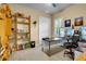 Bright bedroom featuring a desk and shelf with toys, books and collectables at 3198 Thatcher Ln, Tarpon Springs, FL 34688